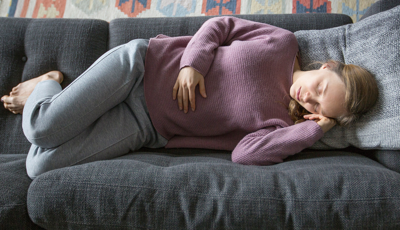 Woman holding her stomach because it hurts