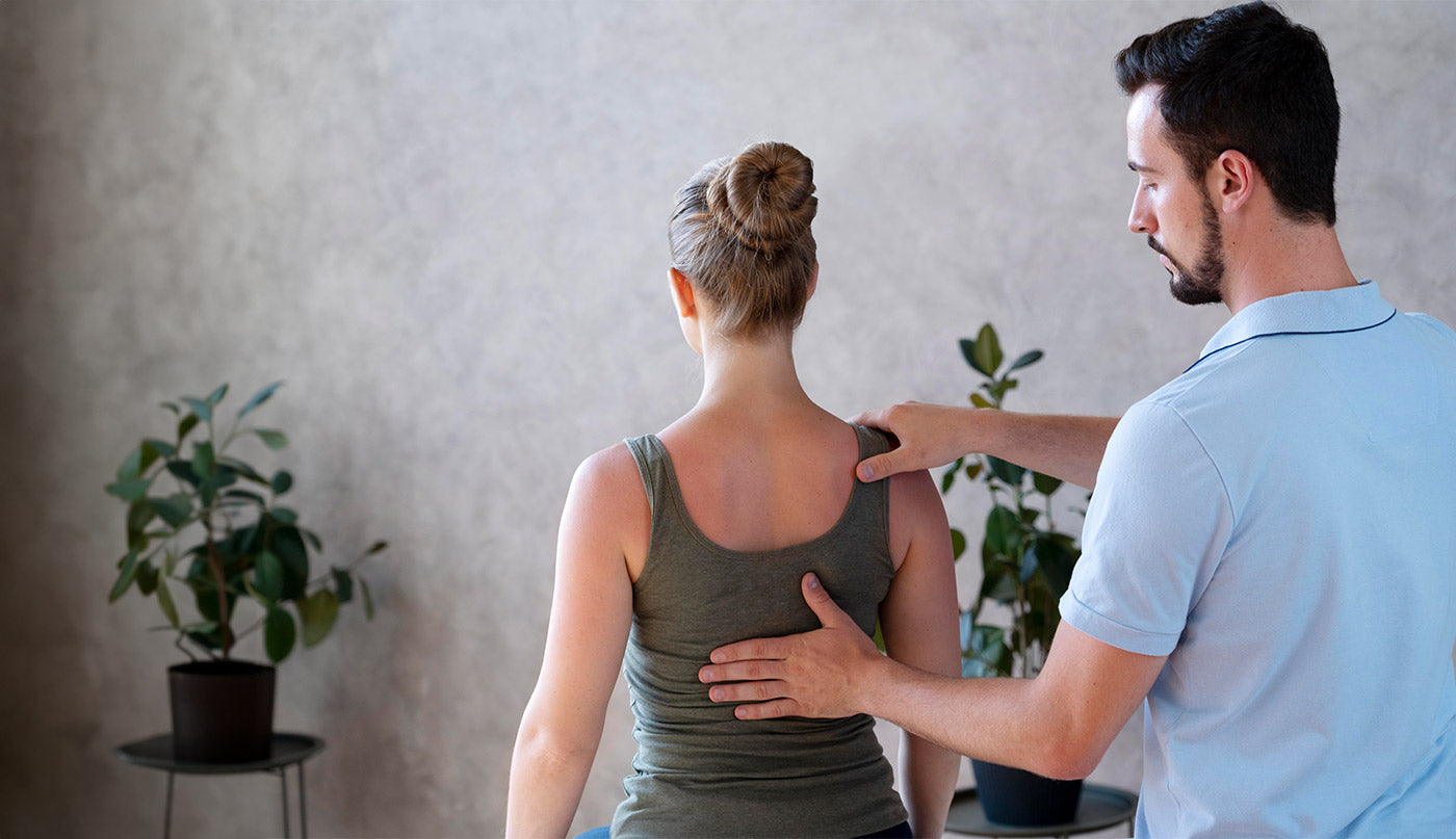 Doctor helping a patient with back pain