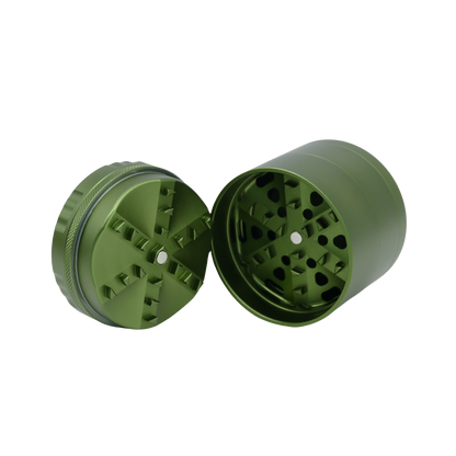 Green metal grinder with two halves on a white background