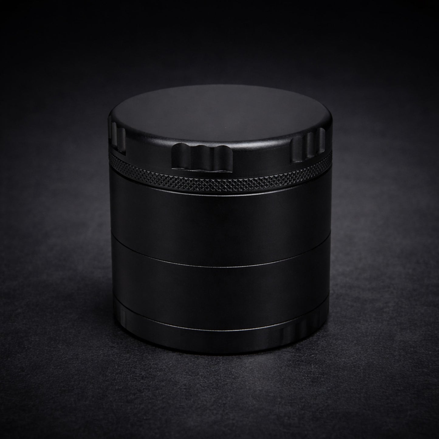 Black cylindrical grinder on a dark background