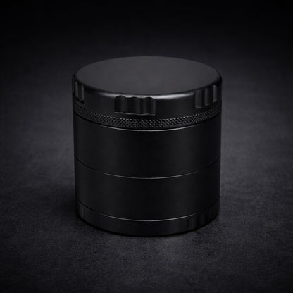 Black cylindrical grinder on a dark background